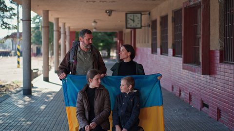 Ukrainian refugee family in station waiting to leave Ukraine due to the Russian invasion of Ukraine.