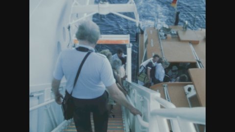 BASSETERRE, SAINT KITTS 31 DECEMBER 1984: People enter the ship's lifeboat in 80s