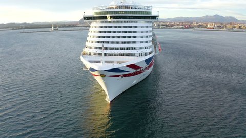 ALICANTE, SPAIN – JANUARY 16, 2022. Aerial view of the great cruise ship IONA maneuvering for leave the port of Alicante, in the Mediterranean coast of Spain.