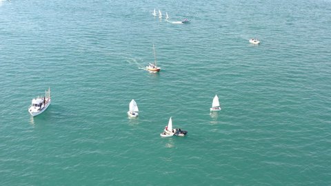 ALICANTE, SPAIN – JANUARY 8, 2022. Aerial view of groupes of Optimist sailboats before the starting of a regatta in Alicante, in the Mediterranean coast of Spain.