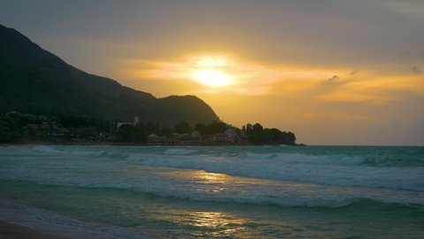 Sunset over the Beau Vallon Beach on the island of Mahe, Seychelles. Beau Vallon Beach is well-frequented and is possibly the most popular beach on the island. 4K UHD video.