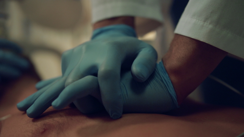Doctor give resuscitation to dying patient closeup. Cardiac massage in hospital. Unknown medical workers team making cpr artificial respiration to sick man in hospital ward. Clinic staff saving life. Royalty-Free Stock Footage #1089219081