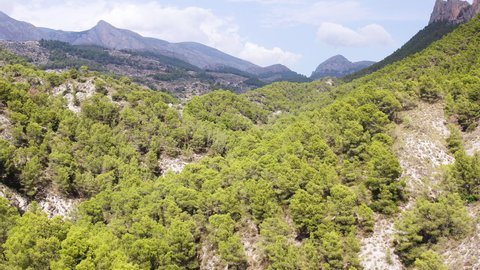 Aerial view of the spectacular rock formations, cliffs and Mediterranean pine forests of the Sierra Dels Castellets, in the area near the town of Villajoyosa, in Alicante, Spain.