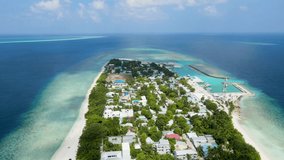 Tropical island in Maldives with white sand beach and turquoise sea water. Touristic vacation holidays travel destination. Scenic landscape. Drone aerial video footage. Ukulhas, North Ari Atoll.