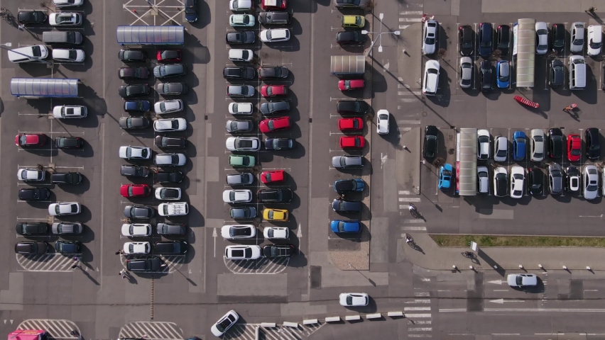 Aerial timelapse of parking lot near shopping mall, Top view of parked cars on parking spots, City transport
