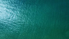 Sea, top view. Reflection of the sun and calm waves. Real top view of the ocean from a drone