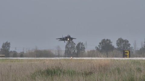 Andravida Greece APRIL, 1, 2022 Military plane lands with nose up. Aerodynamic braking follow shoot in 4K. Boeing F-15E Strike Eagle American multirole fighter jet of United States Air Force USAF