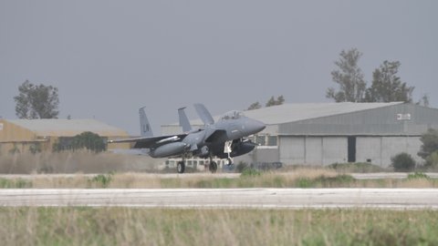 Andravida Greece APRIL, 1, 2022 Grey NATO air forces combat aircraft land with air brake opened and nose up to slow down the speed. Boeing F-15 Strike Eagle fighter jet of United States Air Force USAF