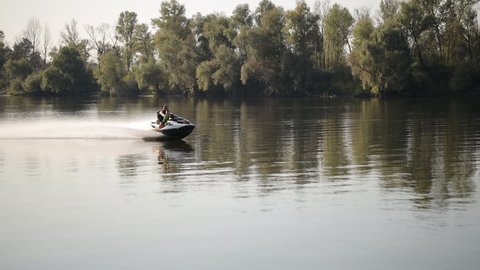 Kiev, Ukraine - September 11, 2021: Father and son ride on the river on a jet ski. Father and son on jet ski