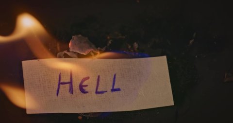 Closeup video of burning paper with ANGUISH written on it