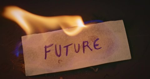 Closeup video of burning paper with FUTURE written on it