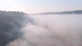 Gorgeous landscape covered with thick morning fog. Footage from a bird's eye view. Location place Dniester canyon, Ukraine, Europe. Cinematic drone shot. Filmed in UHD 4k video. Beauty of earth.
