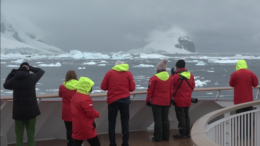 Cruise ship in Antarctica. Travel to the Antarctic peninsula. A beautiful polar nature with mountains, glaciers and icebergs. Snow covered mountains and Lemaire Channel.