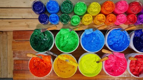 top view of colorful ink in factory tee shirt.Different colors are organized for t-shirt printing.The color of the ink lays neatly on the wooden floor.
colorful of ink background.