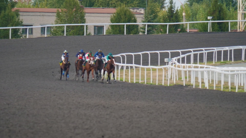 Riders compete in equestrian sport. Horsemen in helmets ride horses at high speed. Equestrians try to come first. Horserace, winning, betting, adrenaline, risk, chance, luck, fortune
