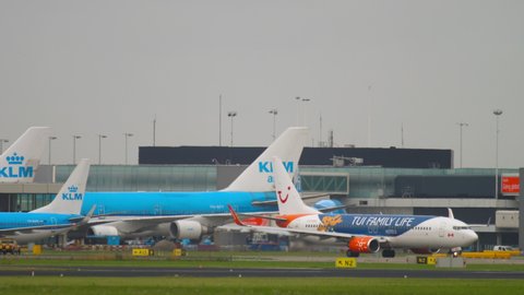 AMSTERDAM, THE NETHERLANDS - JULY 27, 2017: Boeing 737 passenger livery TUI FAMILY LIFE taxis from the terminal to the airfield at Schiphol Airport