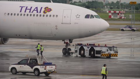 BANGKOK, THAILAND - NOVEMBER 11, 2017: Thai Airways aircraft on the terminal platform being towed to the runway at Suvarnabhumi Airport. Tourism and travel concept
