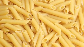 Dry uncooked Italian macaroni rotating close up. High quality 4K footage