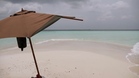 Desert island with umbrella, Maldives