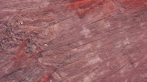 Aerial top view of red muck on construction site