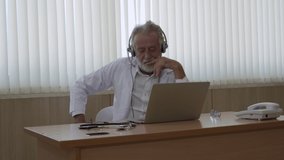 The senior doctor wears a headset. Remote online medical chat consultation, and telemedicine distance services. Telehealth concept, 4k footage video

