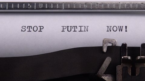 Kyiv, UKRAINE - APRIL 02, 2022: Typing phrase "STOP PUTIN NOW !" on retro typewriter.