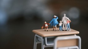 School desk and miniature family