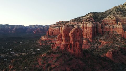Panning aerial drone shot of Red rocky mountains and hills. Red Bell Rock, End of Trail of Cathedral Rock with a beautiful and serene natural view. Sedona, Arizona, USA. 4K UHD