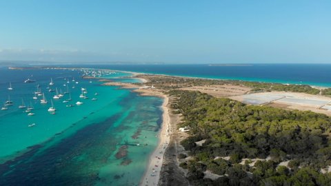 Drone video of Ses Illetes island in Formentera, surrounded by yatchs, Ibiza, Spain