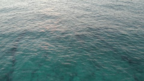 Drone video of crystal clear sea water during sunset in Formentera, Spain