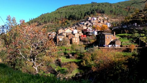 SLOW MOTION SHOT - The picturesque little schist village of Piodão clings to a steeply terraced mountainside deep within the foothills of the Serra de Açor range in central Portugal.