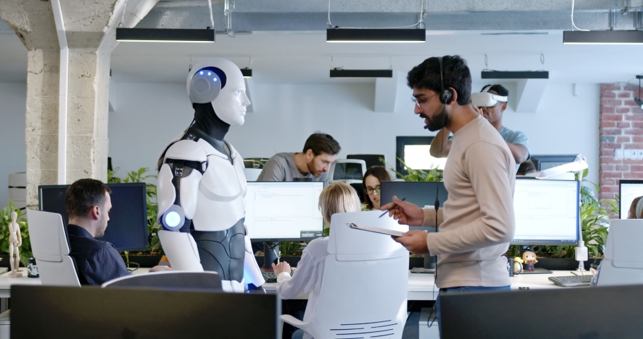 Indian man speaking to robot in office. Male developer checking work and moves of cyborg. Coworking space. Humanoid moving and executing instructions and orders. Artificial intelligence Startup. Royalty-Free Stock Footage #1089255253