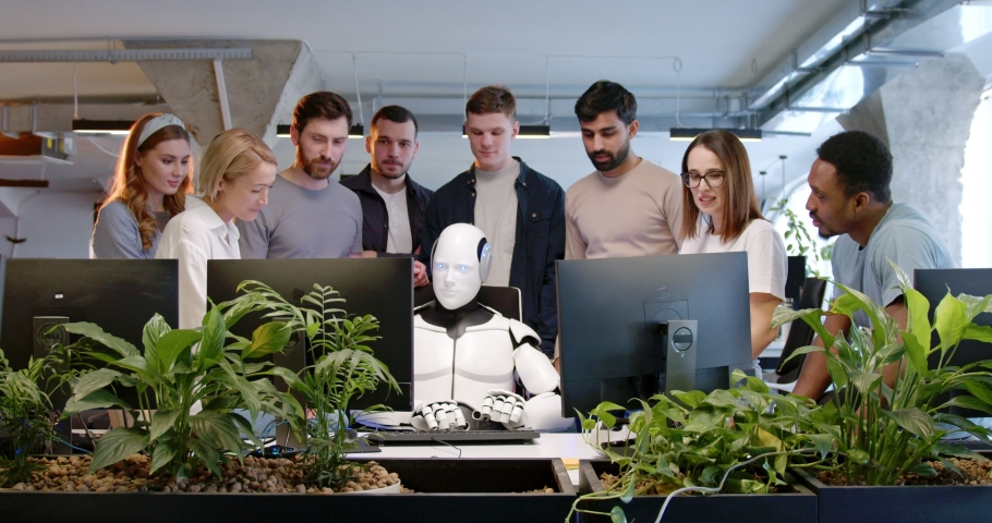 Robot in office, typing on keyboard. People around applauding. Artificial intelligence working at computer in coworking space. IT developers. Humanoid worker. Team cheering up. Artificial intelligence Royalty-Free Stock Footage #1089255287