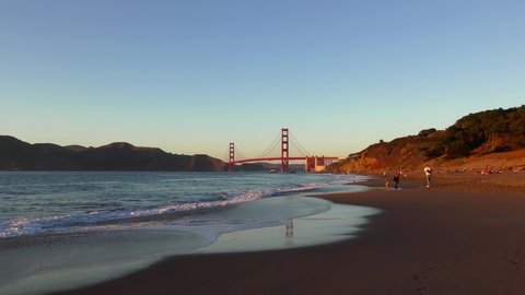 Unidentified people at Baker Beach in San Francisco, California, the Golden Gate bridge in the background, 2018
