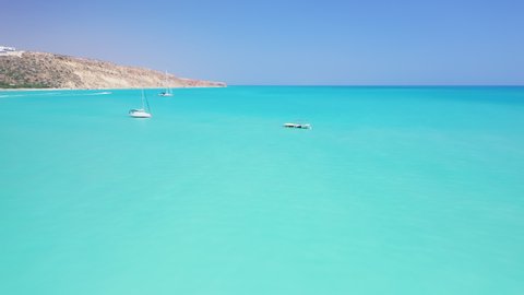 Aerial Mediterranean sea bay lagoon azure blue water. Beautiful Cyprus summer travel holidays seascape. Sailboats in harbour. Paphos coastline with turquoise clear sea water.