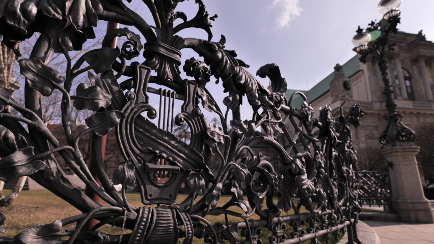 Ancient fence in the center of Old Warsaw. Adam Mickiewicz Monument. Warsaw (Poland).