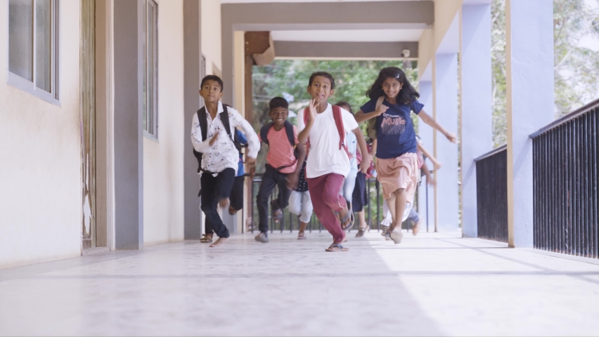 Enjoying group of kids running to school corridor for while going to classroom - concept of education, reopen school, active childhood and learning. Royalty-Free Stock Footage #1089264201