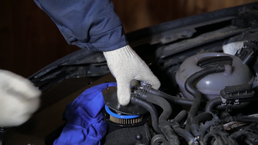 An automobile mechanic removes an old dirty fuel filter from a car. Vehicle fuel system maintenance, close-up Royalty-Free Stock Footage #1089264539