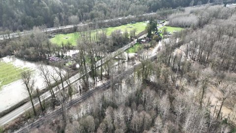 Cinematic 4K bird's-eye drone shot of flooded fields, flooding on the Duwamish, Green River near the Neely Mansion in Auburn, King County Washington