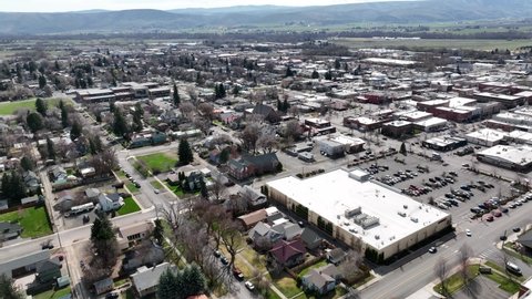 Cinematic 4K aerial drone dolly in shot of the commercial zone of the city of Ellensburg, Kittitas County in Western Washington