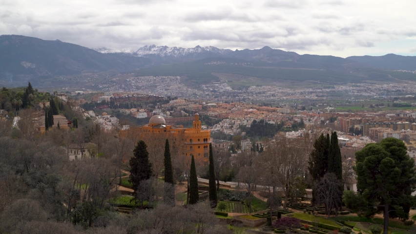 Panoramic view over Granada outskirts and Sierra Nevada mountains with snow