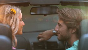 Animation of light over happy caucasian couple kissing in car. love, romantic relationship and valentines day concept digitally generated video.