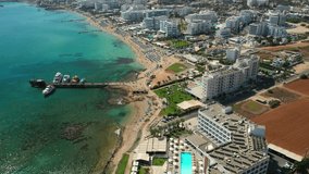 Flying over the Mediterranean Sea beach and hotels in tourist Protaras, Cyprus, aerial video