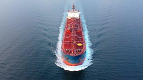 Flying over a crude oil tanker underway in open sea. Bow, forecastle, red upper deck, pipe lines, winches, wheelhouse, upper running bridge, radar mast of a supertanker ship on ride. Aerial, close up
 - Powered by Shutterstock - Get 15% off with code: PIKWIZARD15