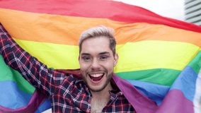 Gay man with makeup on waving rainbow flag outdoor - LGBTQ drag queen concept - Powered by Shutterstock - Get 15% off with code: PIKWIZARD15