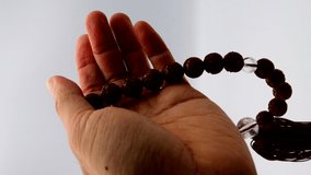 A person who prays with beads