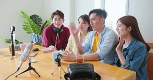 side view of young happy asian friends sharing content on streaming platform with digital web camera - Modern lifestyle have fun vlogging live feeds on social media networks