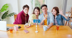 Young happy asian friends sharing content on streaming platform with digital web camera - Modern lifestyle concept with smart millenial guys and girls having fun taking a selfie