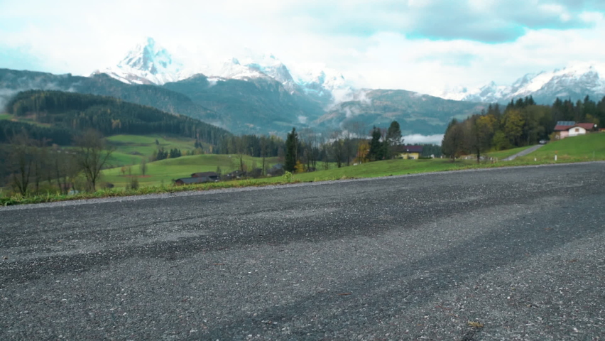 Man Walks along the Mountains to the Top. Tourist in Boots Going along the Stone Road on the Background a Beautiful Landscape. Travel Concept Active People on the Way to Victory Move Forward Close Up