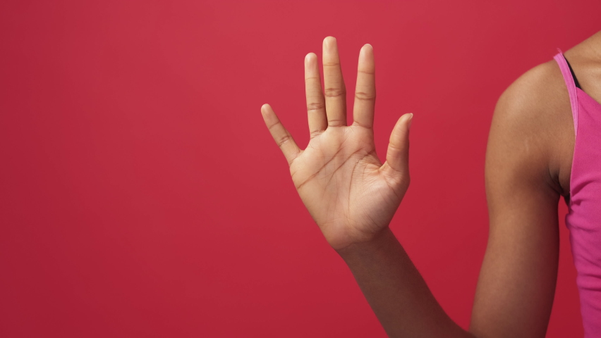 Hand numbers. Finger counting. Countdown gesture. Unrecognizable female palm showing numerals from one to five isolated on red copy space background. Royalty-Free Stock Footage #1089286631